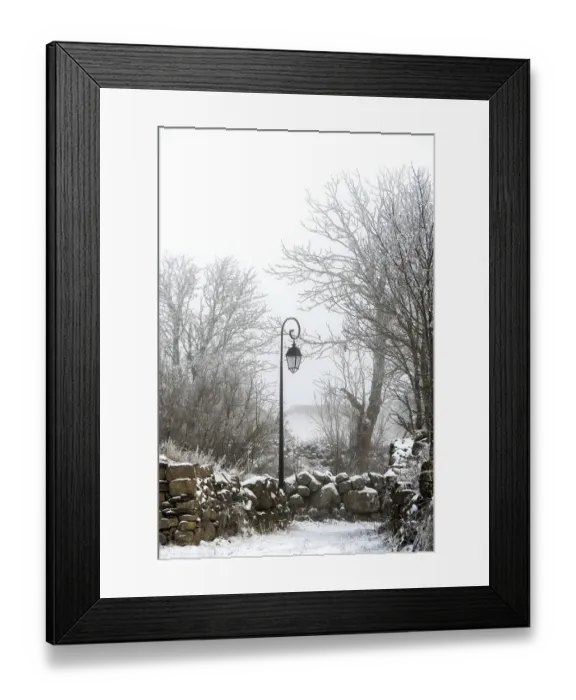 Framed Print : A vintage lamp post stands still amidst a snowy landscape