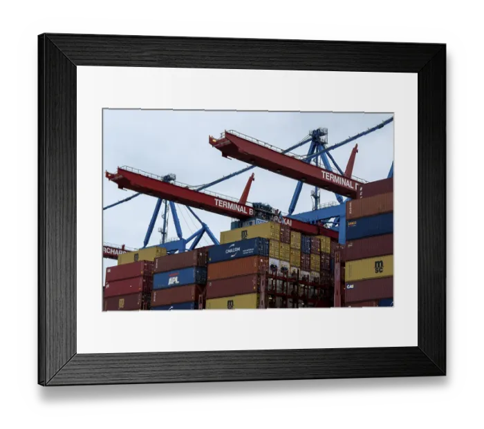Framed Print : Containers and container gantry cranes against a grey sky at the Burchardkai container terminal in the port of Hamburg Framed Print : Containers and container gantry cranes against a grey sky at the Burchardkai container terminal in the port of Hamburg