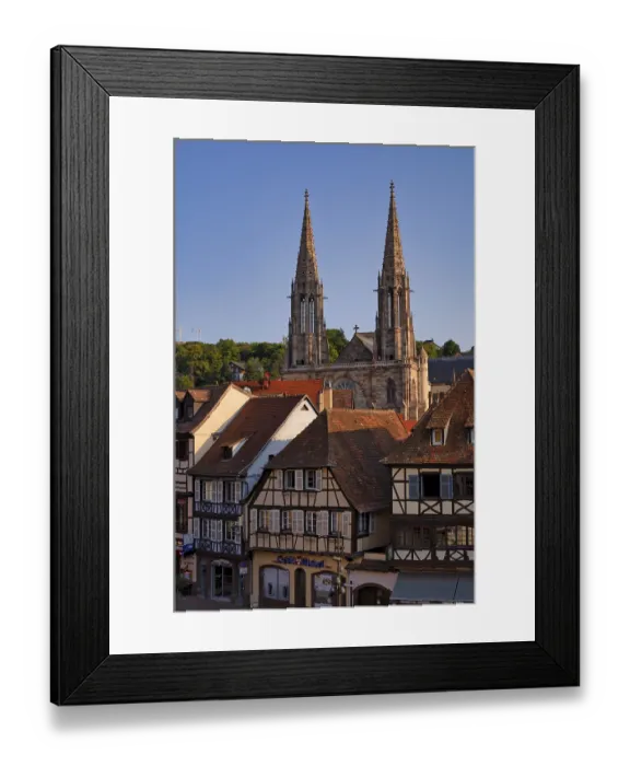Framed Print : View over half-timbered houses at the market place to church Eglise Saints Pierre et Paul