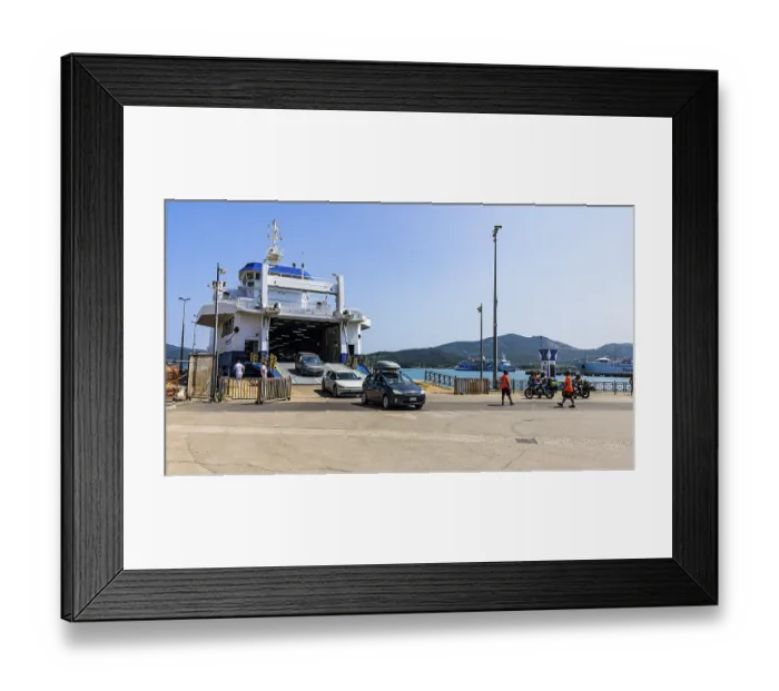 Framed Print : Passenger cars leaving the ferry in the harbour of Portoferraio