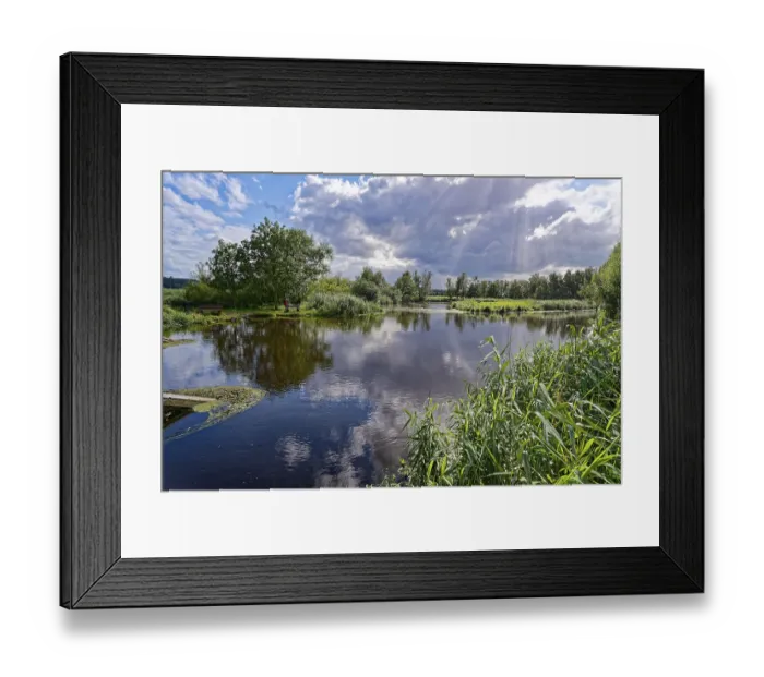 Framed Print : Sun and clouds over the River Trave in Brenner Moor