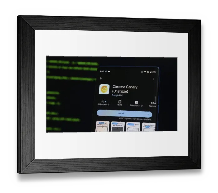 Framed Print : Smartphone showing Chrome Canary app on Google Play with code-like screen reflection in the background Framed Print : Smartphone showing Chrome Canary app on Google Play with code-like screen reflection in the background
