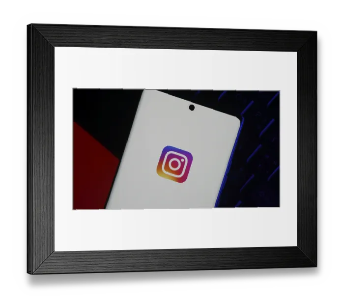 Framed Print : Smartphone displaying Instagram logo on screen over dark background Framed Print : Smartphone displaying Instagram logo on screen over dark background
