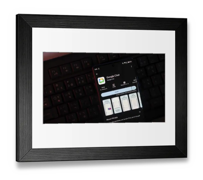 Framed Print : Google Chat app screen on smartphone over keyboard