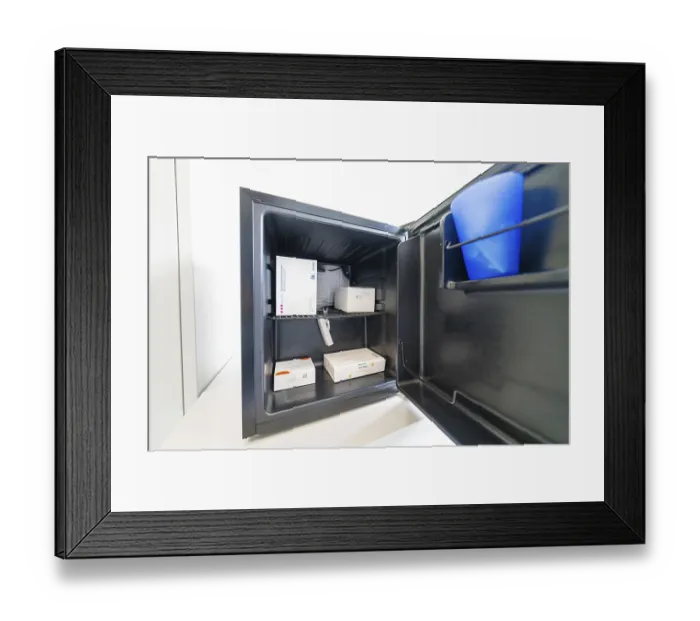 Framed Print : Open freezer with several medicine boxes in the office