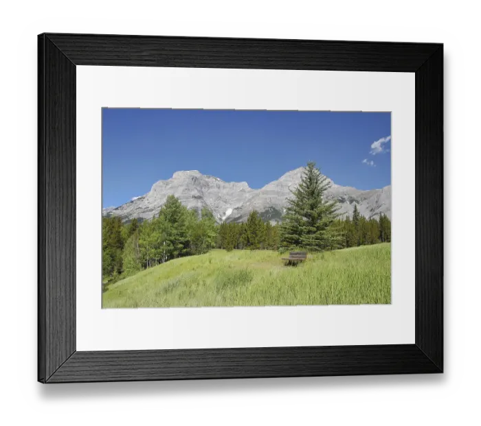 Framed Print : A park bench in the field for taking a break