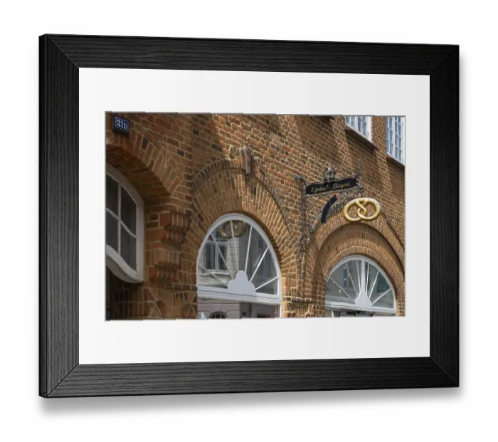 Framed Print : Brick building with bakery and wrought-iron sign