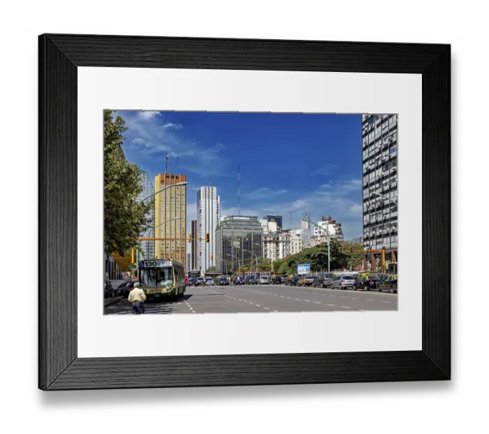 Framed Print : A busy street in a city with many skyscrapers and heavy traffic under a clear sky