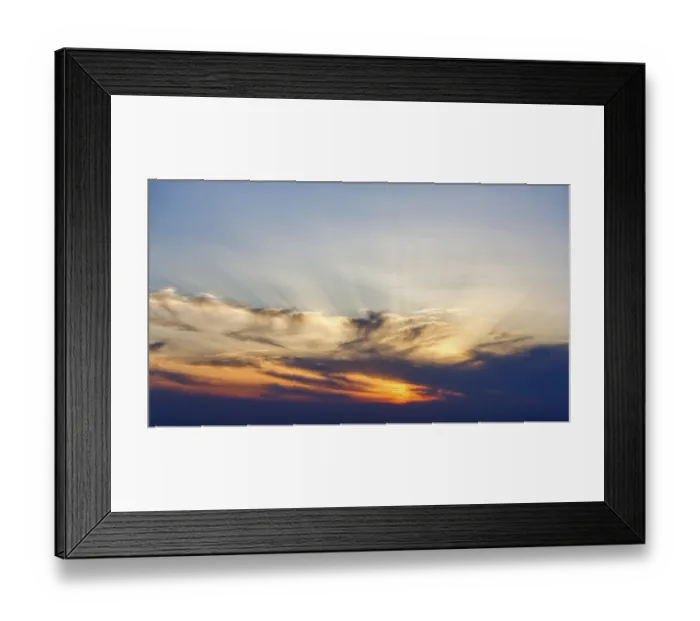 Framed Print : Sunset behind cloud cover, sunbeams