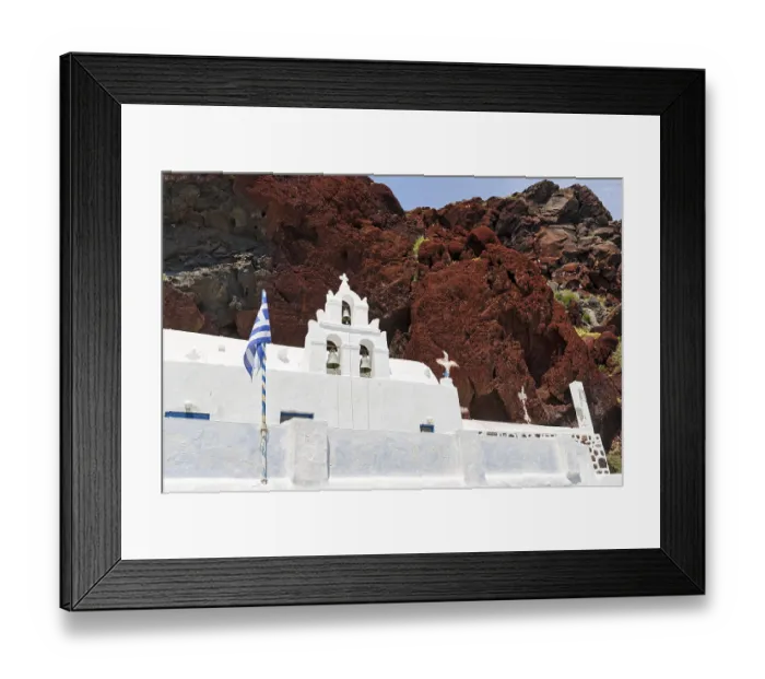 Framed Print : Agios Nikolaos Mavrorachidi, chapel with bell tower and Greek flag in front of red rock face