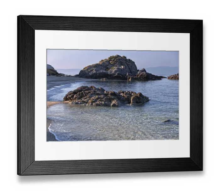 Framed Print : Clear waves lapping rocky coast with calm sea and bright beach Framed Print : Clear waves lapping rocky coast with calm sea and bright beach