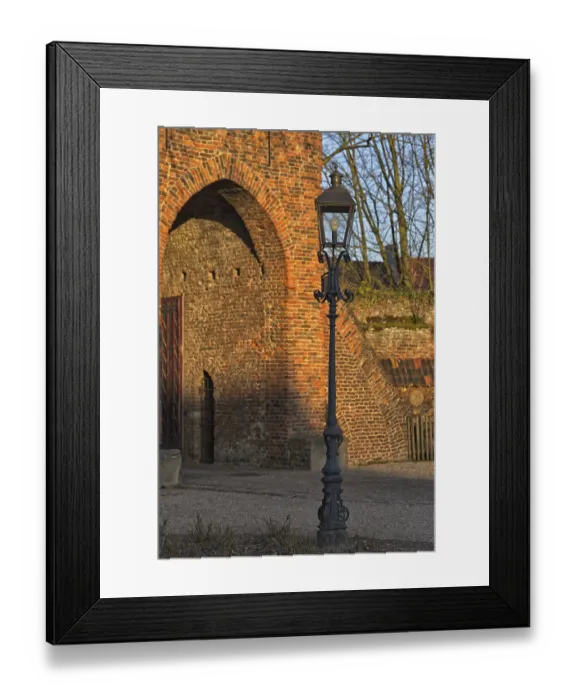 Framed Print : Classic lantern in front of historic brick building (Linn Castle gate) in the light show