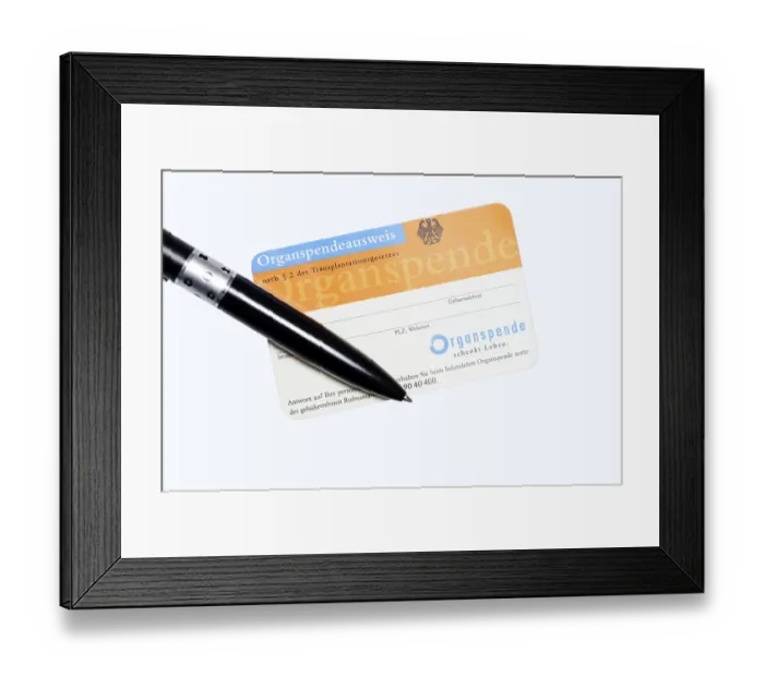Framed Print : Organ donor card with biros on white background
