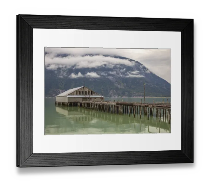 Framed Print : The old abandoned fish cannery on the wooden pier at Bella Coola