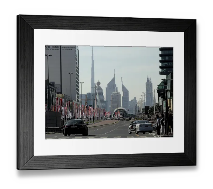 Framed Print : Street with car traffic, flagpoles