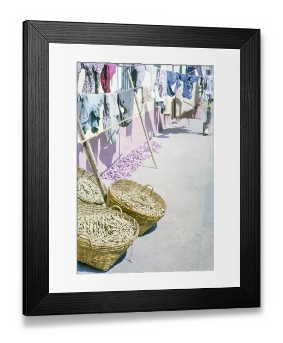 Framed Print : Clothes handing out to dry with baskets of what is thought to be clothes pegs
