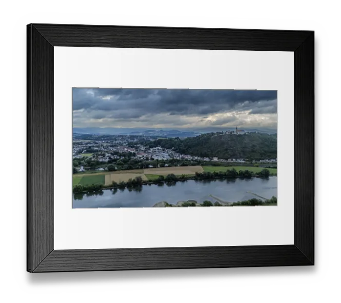 Framed Print : Gloomy clouds drift over the picturesque landscape with the Danube and the Bogenberg