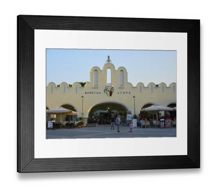 Framed Print : Agora, Municipal market hall, Lively market with white buildings and parasols in the foreground