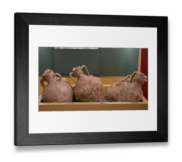 Framed Print : Three ancient amphorae with earth remains on display in a museum