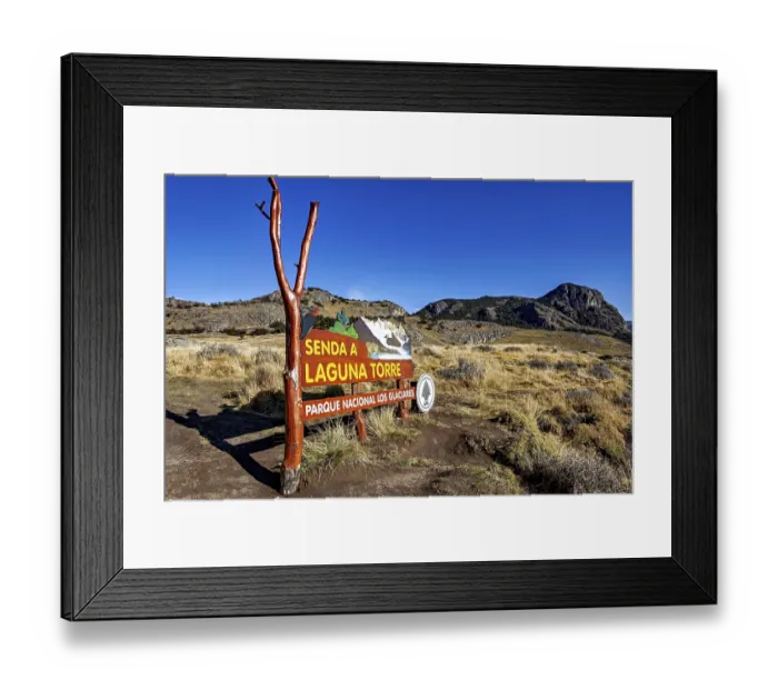 Framed Print : Signpost in the nature park pointing to a hiking trail under a clear blue sky