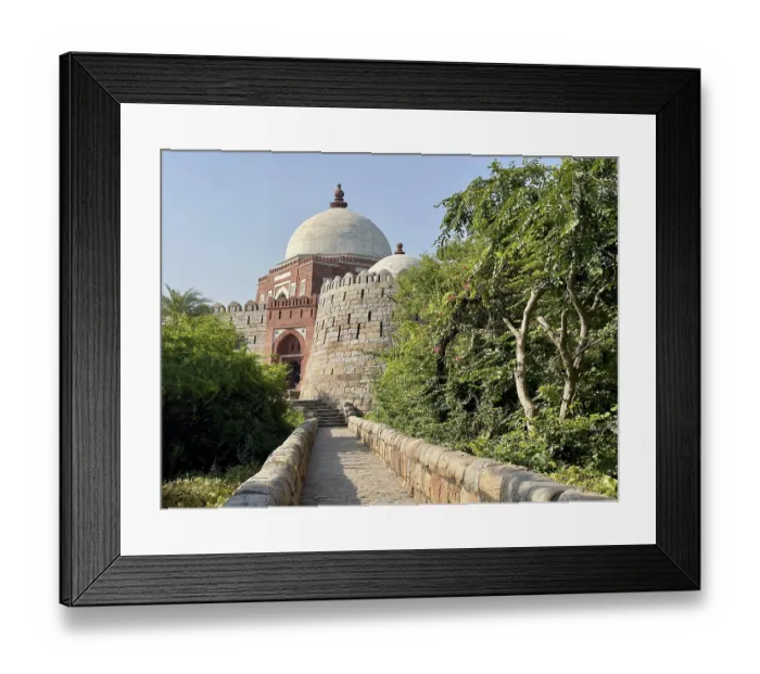 Framed Print : An old tomb surrounded by grass under a clear sky