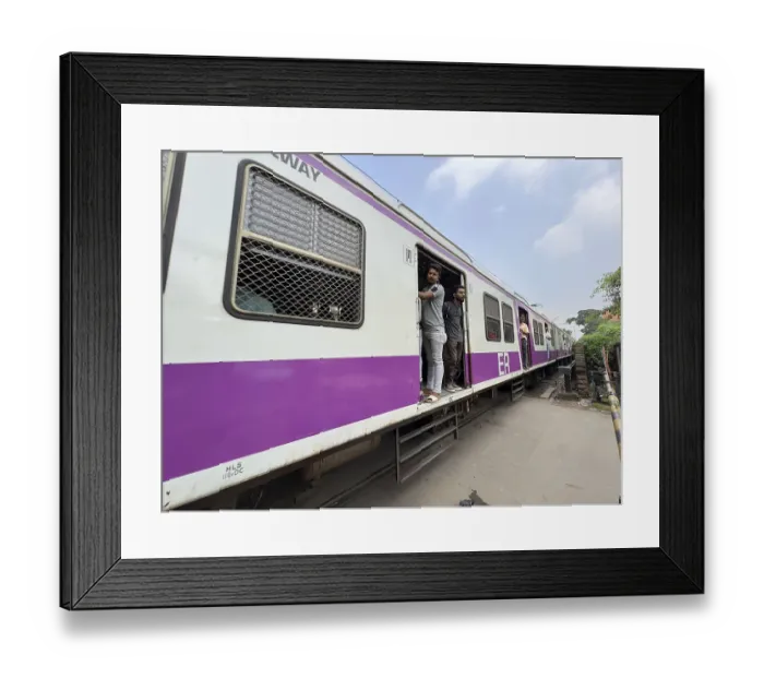 Framed Print : Commuter train with open doors and standing passengers on a railway line