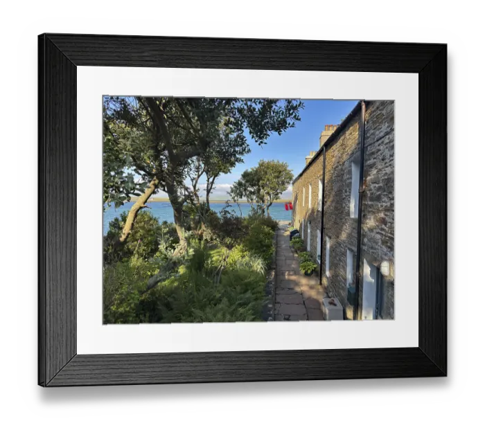 Framed Print : Small stone cottage with garden and sea view in sunny weather Framed Print : Small stone cottage with garden and sea view in sunny weather