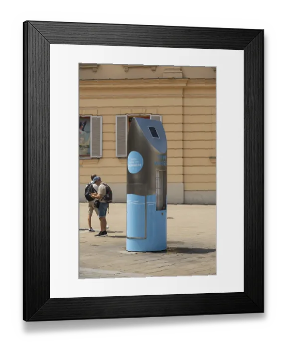Framed Print : Two people in front of a drinking water fountain in the city centre of Vienna Framed Print : Two people in front of a drinking water fountain in the city centre of Vienna