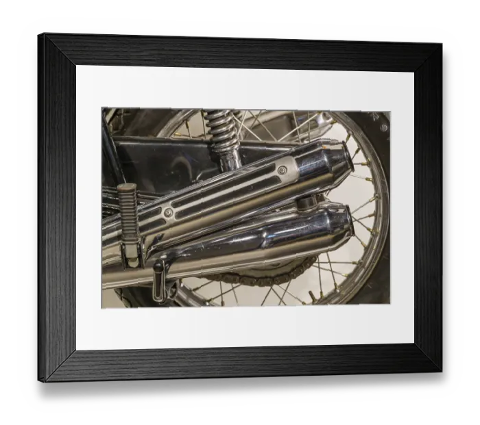 Framed Print : Close-up of a chrome-plated motorbike exhaust and tyre Framed Print : Close-up of a chrome-plated motorbike exhaust and tyre