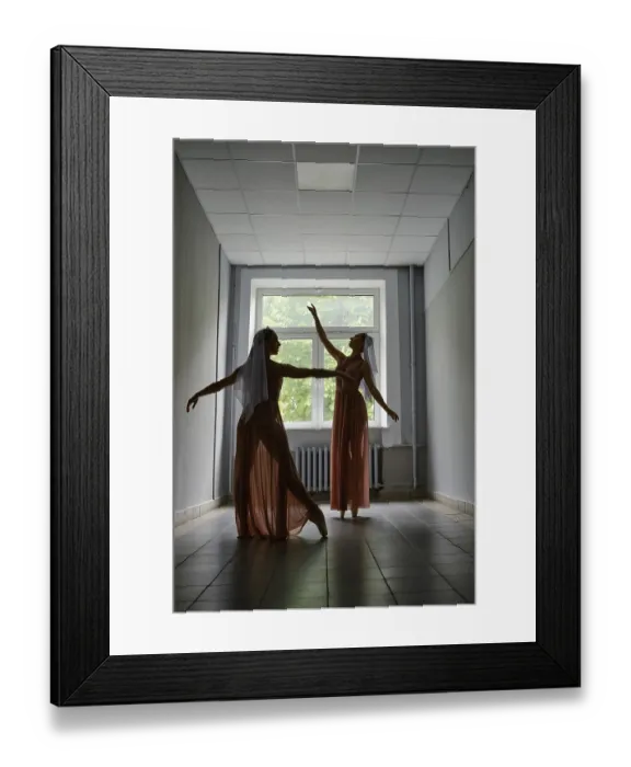 Framed Print : Silhouette of two dancers performing graceful artistic moves with their hands in corridor of theatre