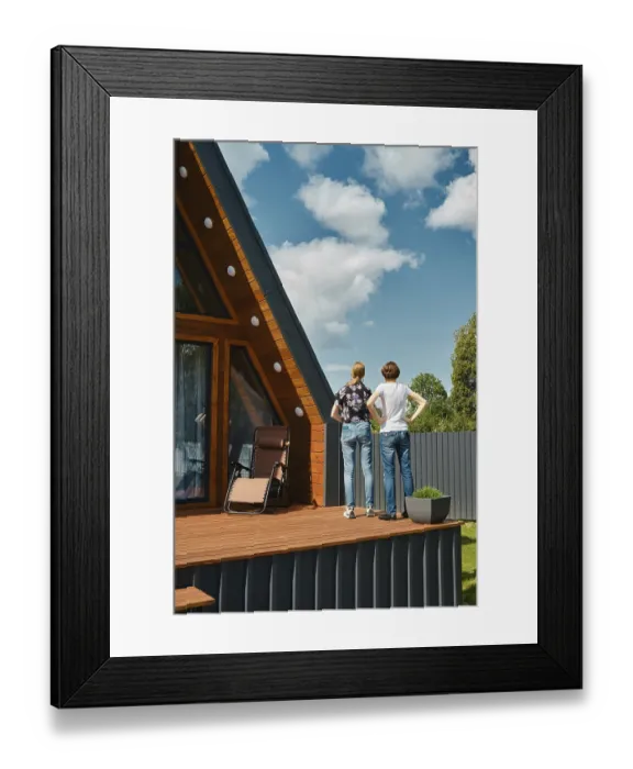 Framed Print : Rear view of mother and daughter standing on terrace of tiny house
