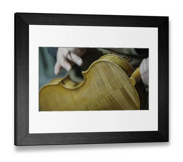 Framed Print : Close-up of a person working on a violin Framed Print : Close-up of a person working on a violin