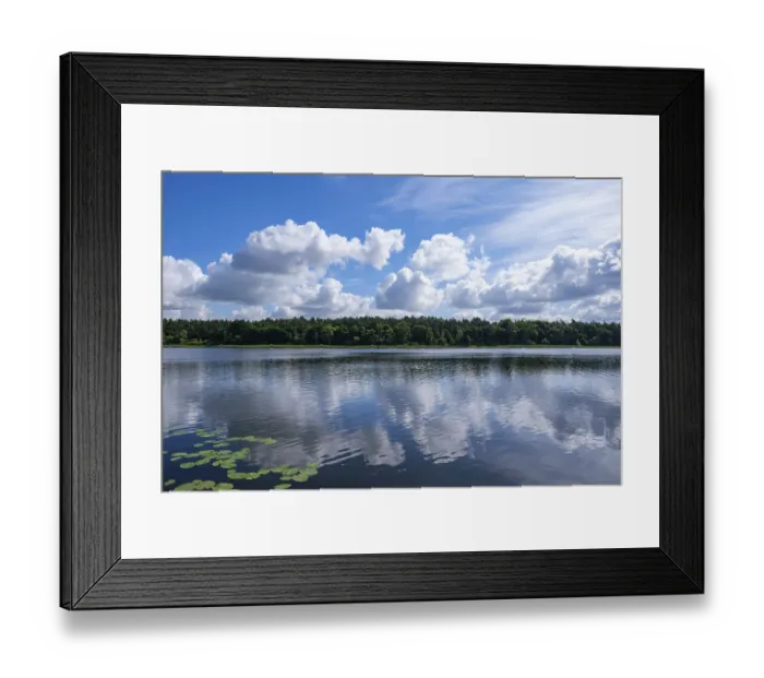 Framed Print : Calm lake with reflection of the clouds in the clear water