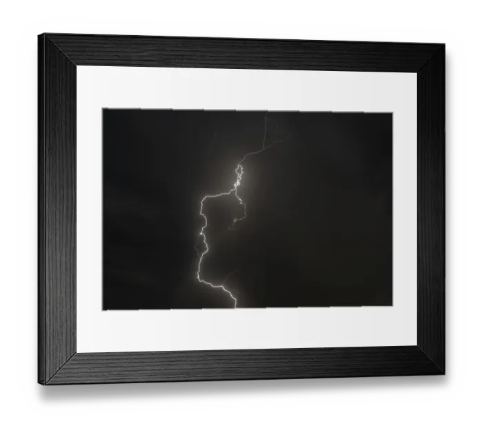 Framed Print : Dark clouds gather as lightning strikes light up the night