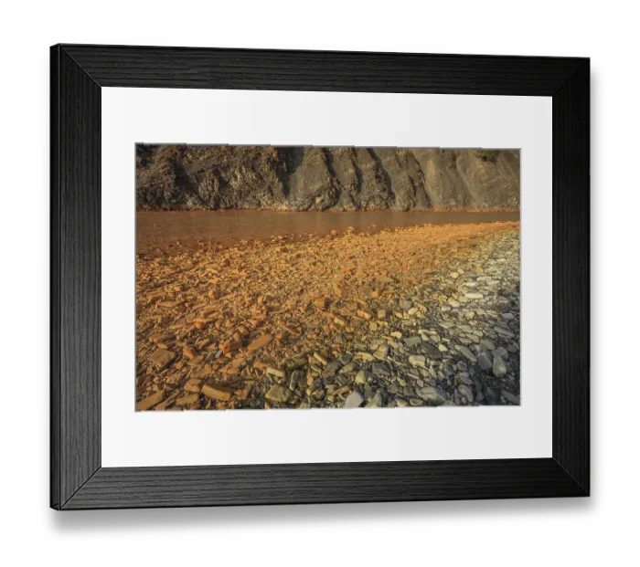 Framed Print : Rocks along the riverbank are stained by dissolved iron and other minerals in the water