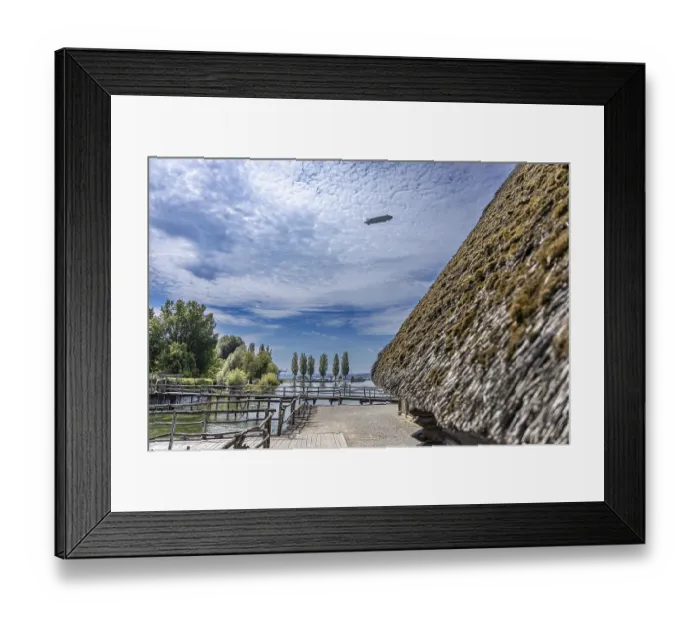 Framed Print : Thatched roof building with a view of trees and clouds in a rural setting Framed Print : Thatched roof building with a view of trees and clouds in a rural setting