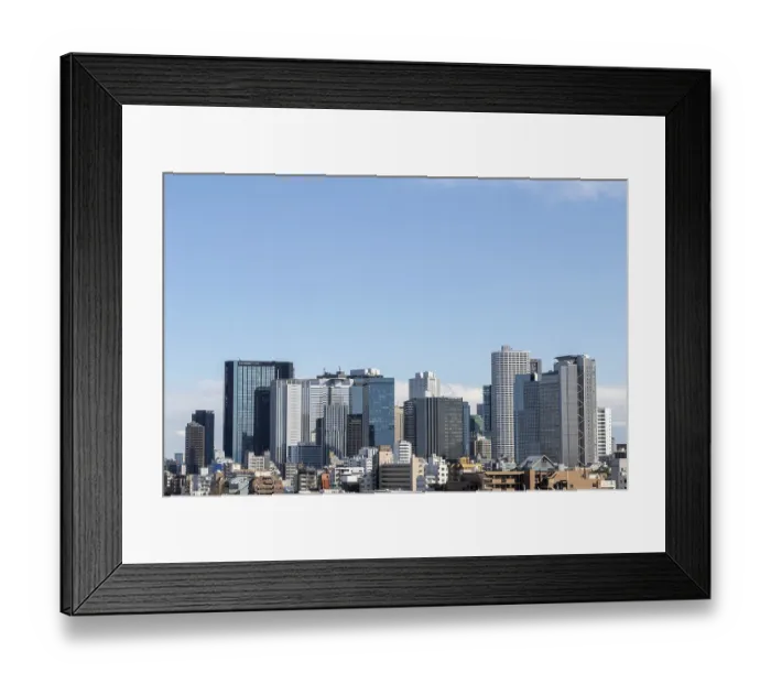 Framed Print : Modern architecture, view over the rooftops of the city to the glass facades of skyscrapers against a blue sky Framed Print : Modern architecture, view over the rooftops of the city to the glass facades of skyscrapers against a blue sky