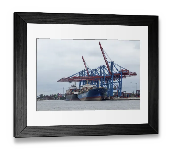 Framed Print : Container ships and container gantry cranes under grey skies on the Elbe at the Tollerort container terminal