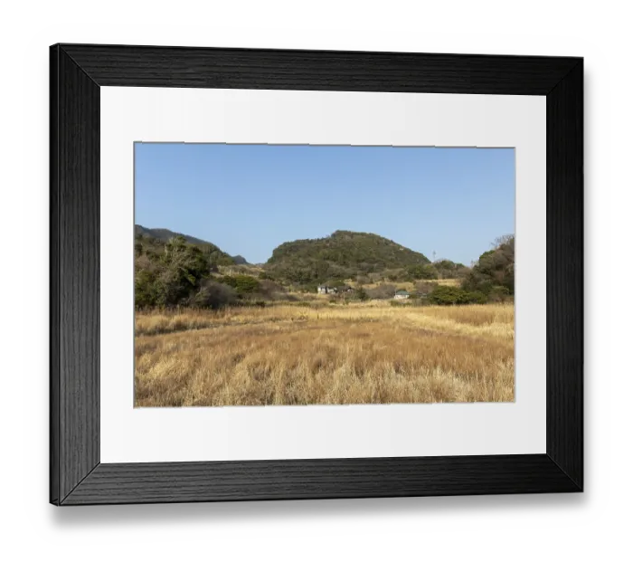 Framed Print : Residential houses in a rural mountain landscape in the evening light