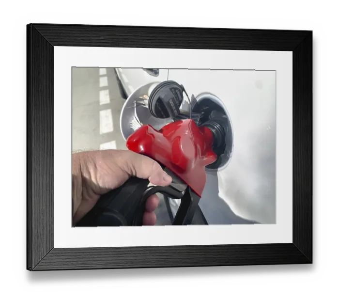 Framed Print : Male hand holding gas pump nossle pumping gas into vehicle Framed Print : Male hand holding gas pump nossle pumping gas into vehicle