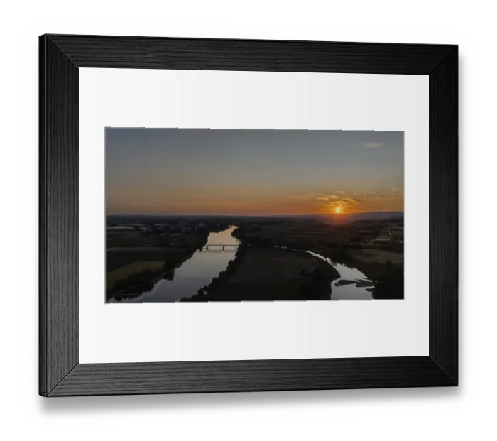 Framed Print : Sunset over a calm river with railway bridge and surrounding landscape