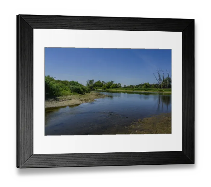 Framed Print : A peaceful river shines under a clear sky
