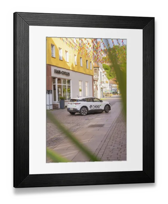 Framed Print : A car parked on a cobbled street with colourful houses Framed Print : A car parked on a cobbled street with colourful houses