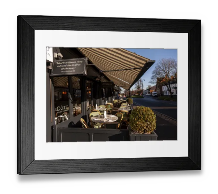 Framed Print : Empty tables outside a cafe on a sunny day