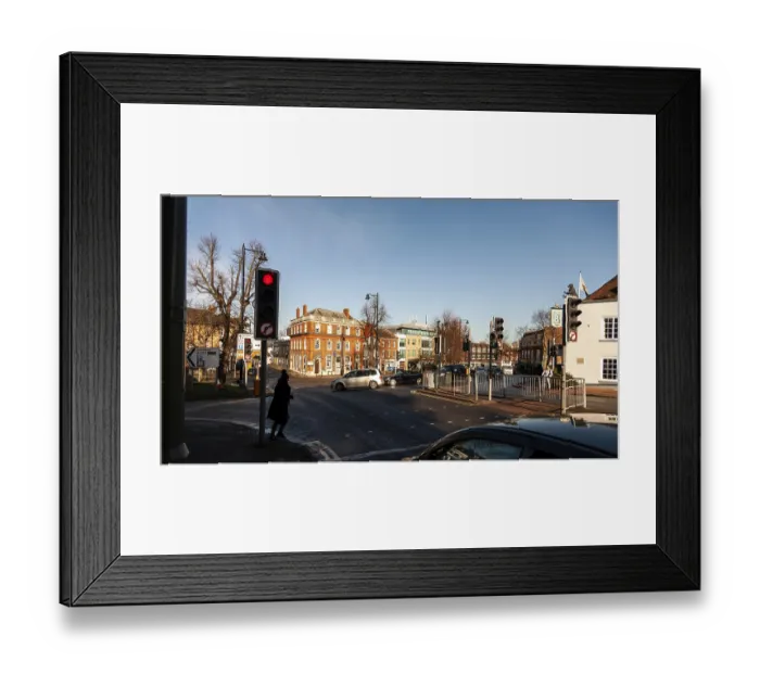 Framed Print : Urban intersection with cars and traffic lights under a clear sky