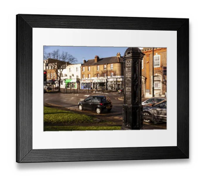 Framed Print : Historical street post with cars and shops