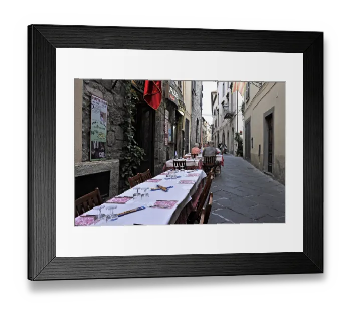 Framed Print : Covered tables, narrow alley with pizzeria