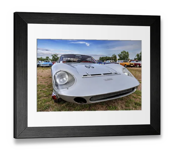 Framed Print : Grey sporty vintage car with retro design in a meadow under a cloudy sky Framed Print : Grey sporty vintage car with retro design in a meadow under a cloudy sky