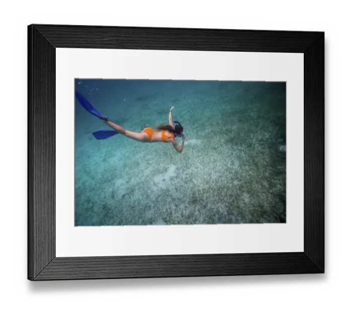 Framed Print : A person snorkeling underwater in clear ocean water Framed Print : A person snorkeling underwater in clear ocean water
