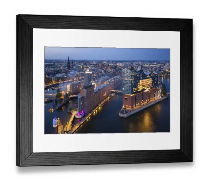 Framed Print : Aerial view of the Elbphilharmonie at blue hour with illuminated windows and view over the Speicherstadt and Hafencity Framed Print : Aerial view of the Elbphilharmonie at blue hour with illuminated windows and view over the Speicherstadt and Hafencity
